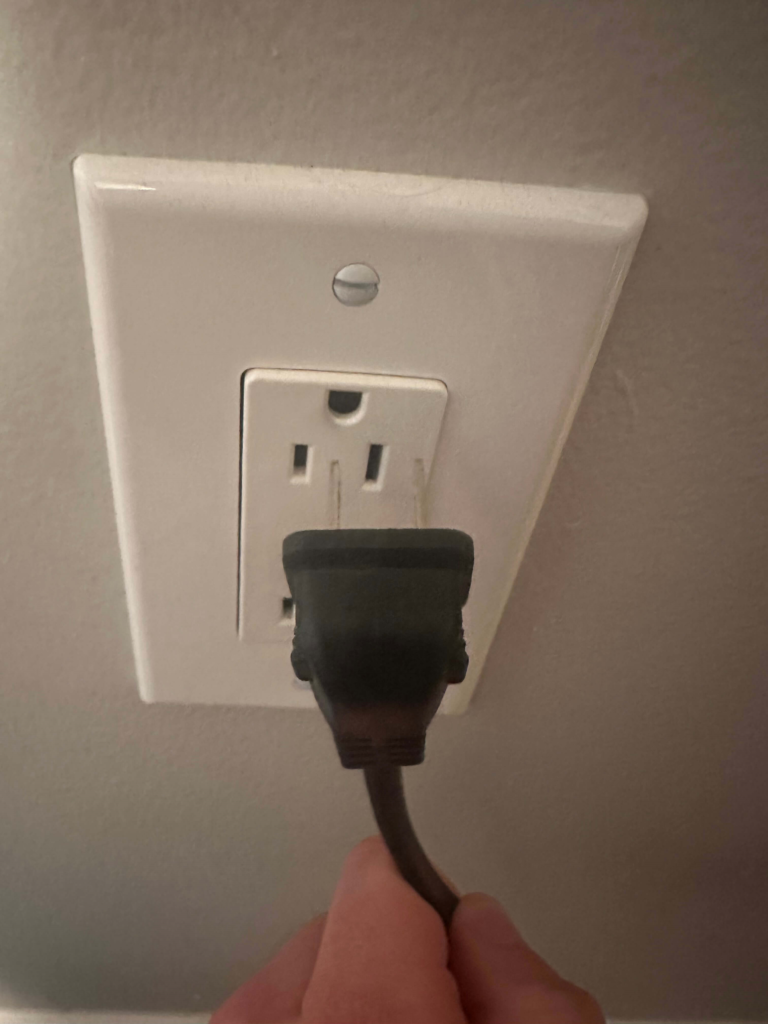 Unplugging Power Cord from Electrical Outlet for TV Green Screen Fix